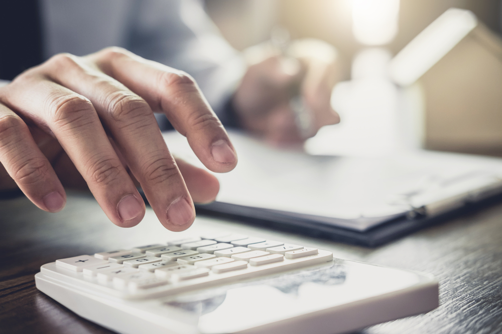 Foreclosure Defense Lawyer - Businessman or lawyer accountant working financial investment on office, using calculator analysis finance document report real estate and home loan insurance.