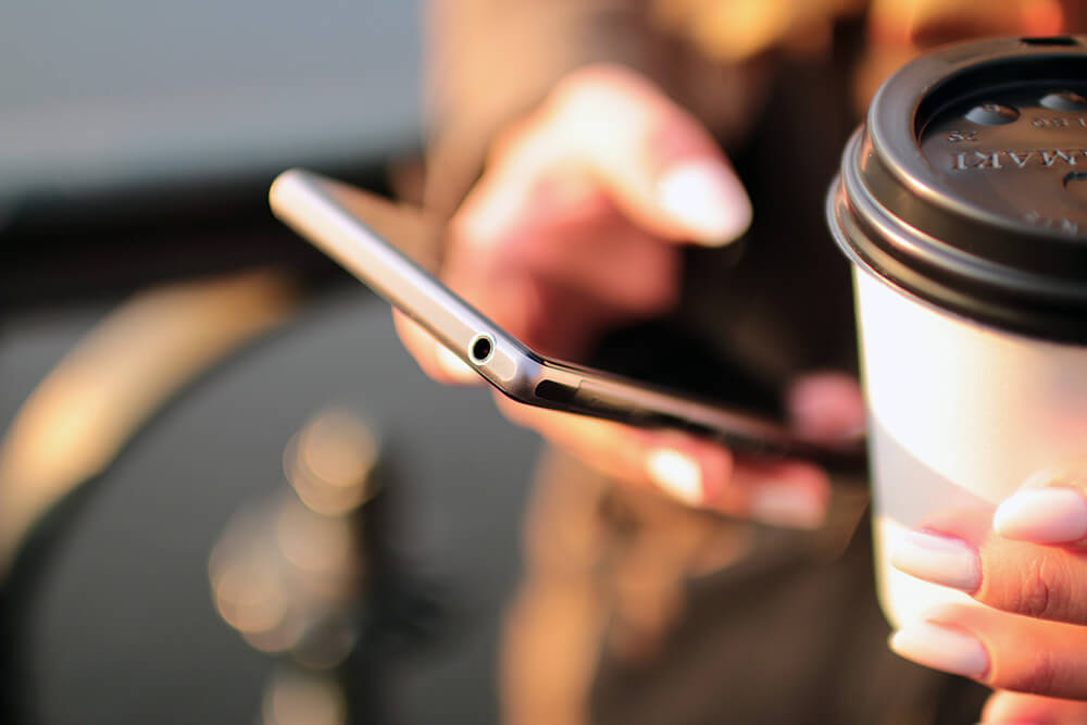 Workers' Comp Lawyer Lancaster, NY - phone with coffee warm light